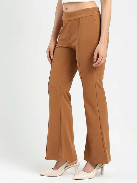 A model wearing flared coffee brown knitted trousers