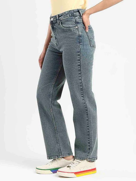 A model wearing mid-wash tinted blue denim jeans